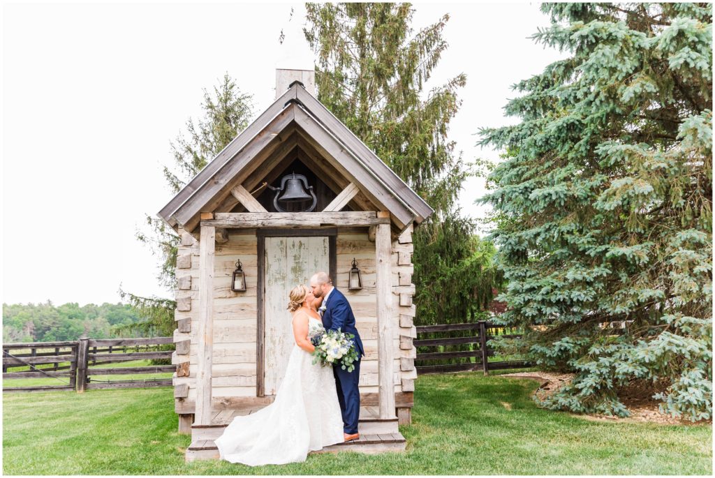 bride and groom portrait in front of a small chapel