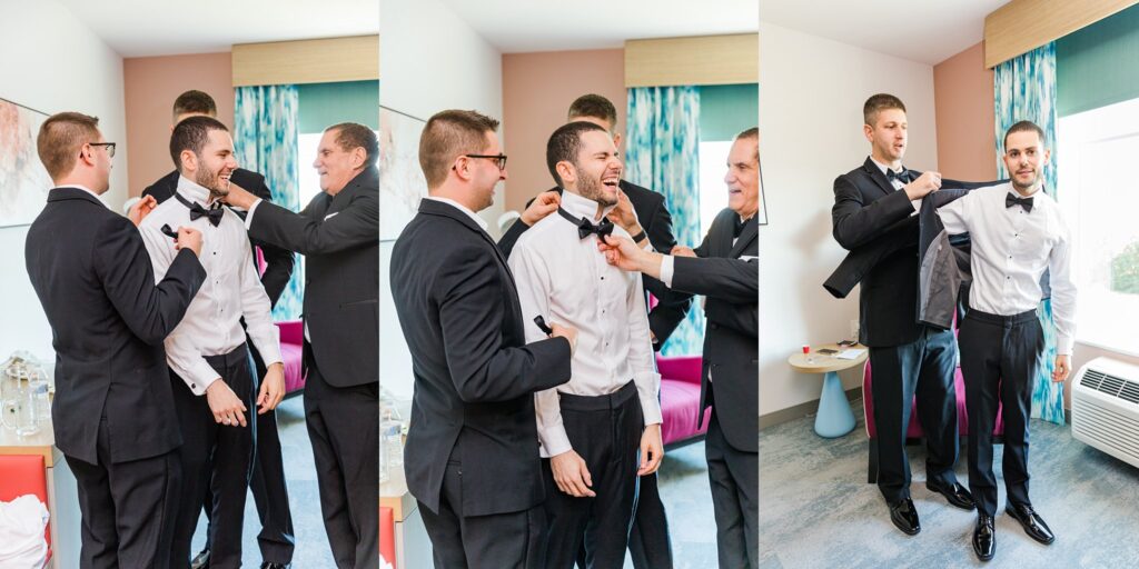 groom getting ready with groomsmen in hotel room